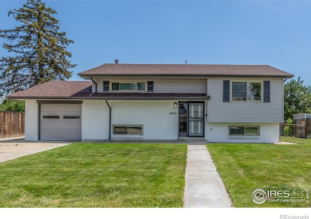 4642 Everett Ct, Wheat Ridge, CO 80033 - view of front of home with a garage, concrete driveway, and brick siding