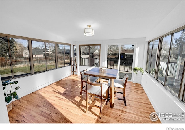 4642 Everett Ct, Wheat Ridge, CO 80033 - sunroom with wood finished floors, a wooden deck, and baseboards