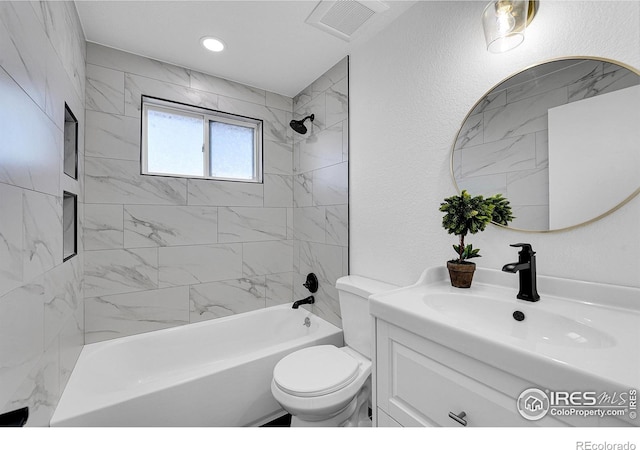 4642 Everett Ct, Wheat Ridge, CO 80033 - bathroom featuring vanity, shower / washtub combination, toilet, and a textured wall
