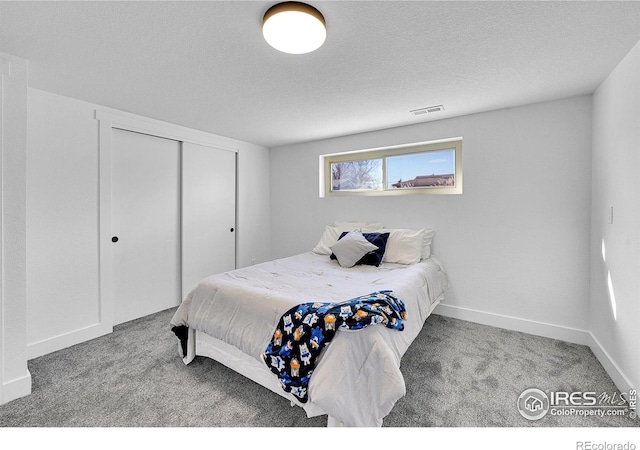 4642 Everett Ct, Wheat Ridge, CO 80033 - bedroom featuring carpet flooring, a closet, a textured ceiling, and baseboards