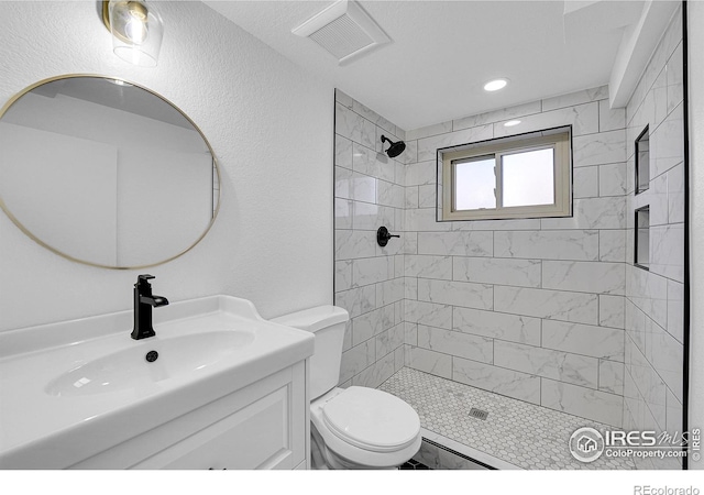 4642 Everett Ct, Wheat Ridge, CO 80033 - full bathroom featuring toilet, a tile shower, and vanity