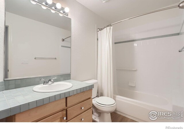 4326 Clay Commons Ct, Boulder, CO 80303 - bathroom featuring shower / bath combo, toilet, vanity, and wood finished floors