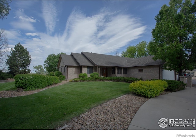 1314 State Highway 66, Longmont, CO 80504 - single story home featuring an attached garage, brick siding, and a front yard