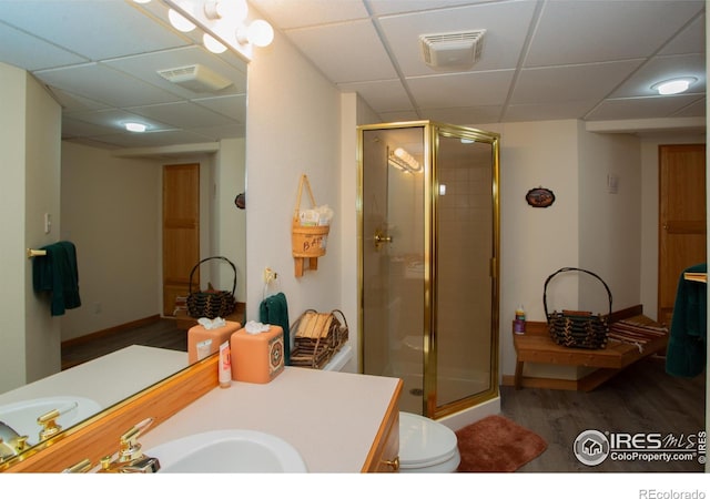 1314 State Highway 66, Longmont, CO 80504 - bathroom with wood finished floors, a drop ceiling, vanity, a shower stall, and baseboards