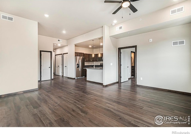 1768 Wildfire Rd Unit 101, Estes Park, CO 80517 - unfurnished living room featuring dark wood finished floors, a ceiling fan, baseboards, recessed lighting, and a sink