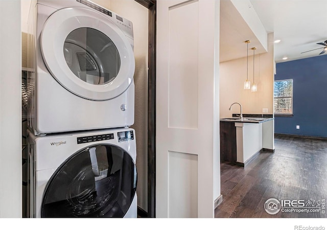 1768 Wildfire Rd Unit 101, Estes Park, CO 80517 - washroom featuring stacked washer / drying machine, dark wood-style flooring, recessed lighting, and baseboards