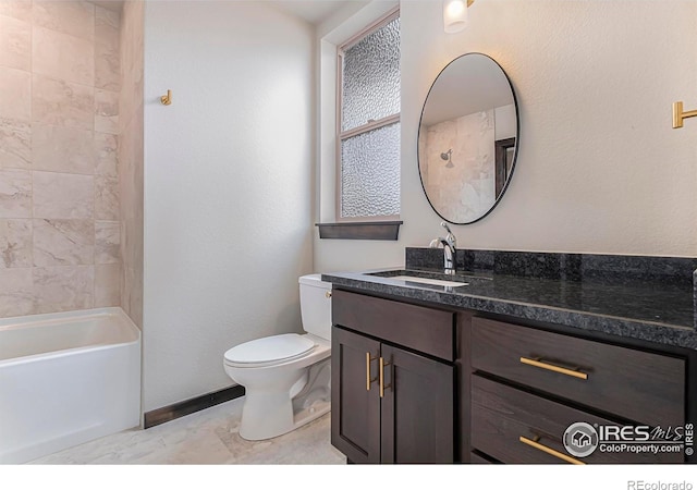 1768 Wildfire Rd Unit 101, Estes Park, CO 80517 - bathroom featuring toilet, vanity, baseboards, and shower / tub combination