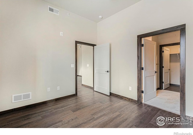 1768 Wildfire Rd Unit 101, Estes Park, CO 80517 - unfurnished bedroom featuring wood finished floors, baseboards, and a spacious closet