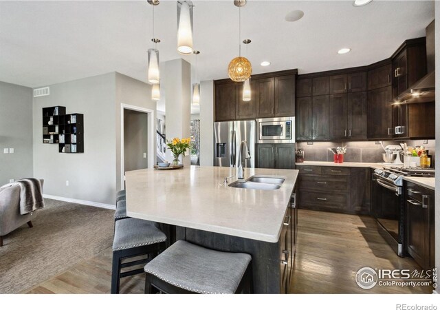 2620 Brush Creek Dr, Fort Collins, CO 80528 - kitchen featuring stainless steel appliances, a sink, light countertops, dark brown cabinets, and recessed lighting