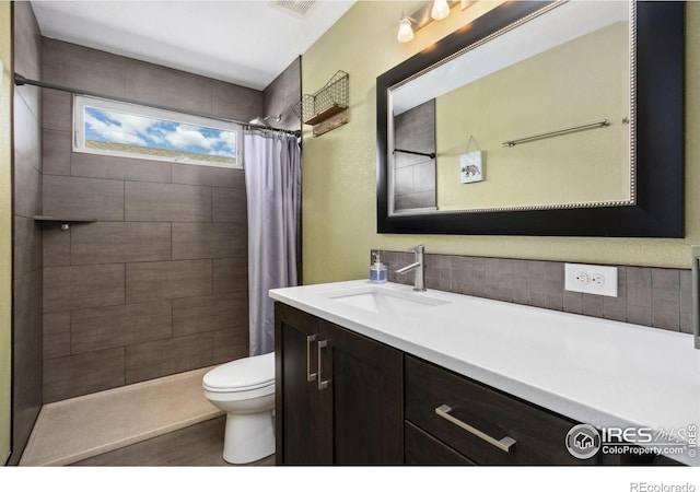 2620 Brush Creek Dr, Fort Collins, CO 80528 - bathroom with toilet, vanity, tiled shower, and wood finished floors