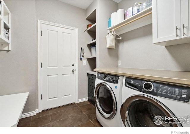 2620 Brush Creek Dr, Fort Collins, CO 80528 - washroom featuring washer and dryer, baseboards, dark tile patterned flooring, and cabinet space