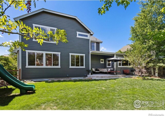 2620 Brush Creek Dr, Fort Collins, CO 80528 - rear view of property with an outdoor hangout area, a patio, a yard, and a playground