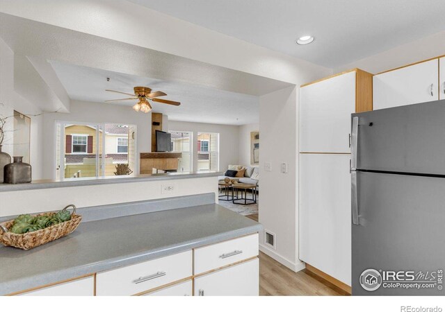 3860 Colorado Ave Unit C, Boulder, CO 80303 - kitchen with freestanding refrigerator, light wood-style floors, a ceiling fan, white cabinetry, and open floor plan
