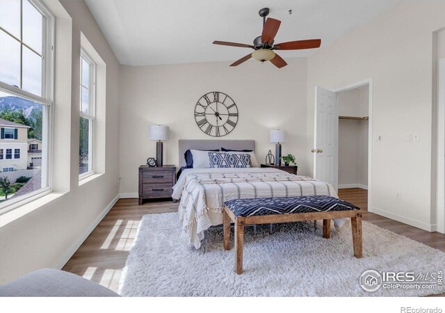 3860 Colorado Ave Unit C, Boulder, CO 80303 - bedroom featuring wood finished floors, baseboards, lofted ceiling, a walk in closet, and ceiling fan