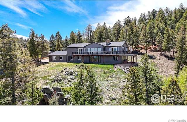 1100 Deer Trail Rd, Boulder, CO 80302 - back of property featuring a wooden deck and a chimney