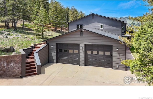 1100 Deer Trail Rd, Boulder, CO 80302 - view of front of property with a garage, driveway, and stairs