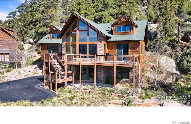 303 Curry Dr, Estes Park, CO 80517 - back of house with stone siding, a wooden deck, and stairs