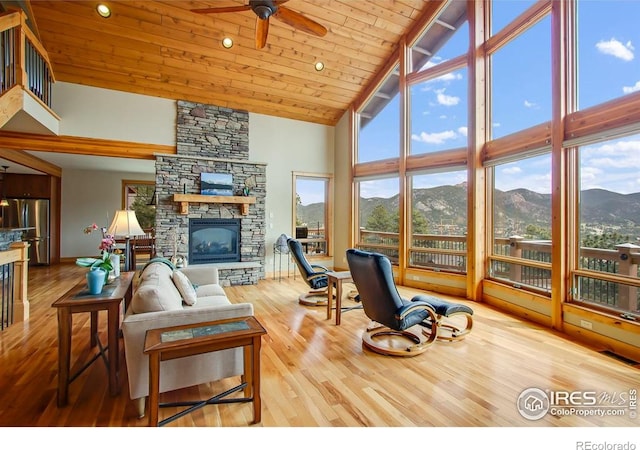 303 Curry Dr, Estes Park, CO 80517 - living area with high vaulted ceiling, a mountain view, a ceiling fan, wood finished floors, and a fireplace