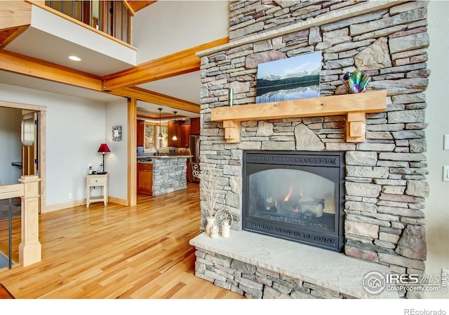 303 Curry Dr, Estes Park, CO 80517 - living room with wood finished floors, a fireplace, beam ceiling, and baseboards