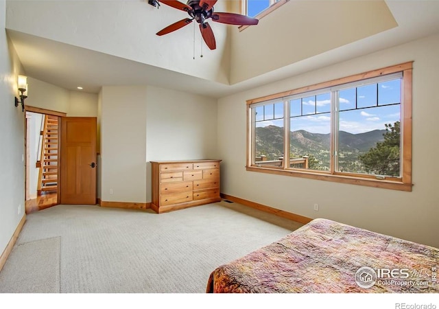 303 Curry Dr, Estes Park, CO 80517 - bedroom featuring light colored carpet, baseboards, a mountain view, a high ceiling, and ceiling fan