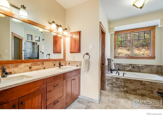 303 Curry Dr, Estes Park, CO 80517 - bathroom with double vanity, a garden tub, tasteful backsplash, and baseboards