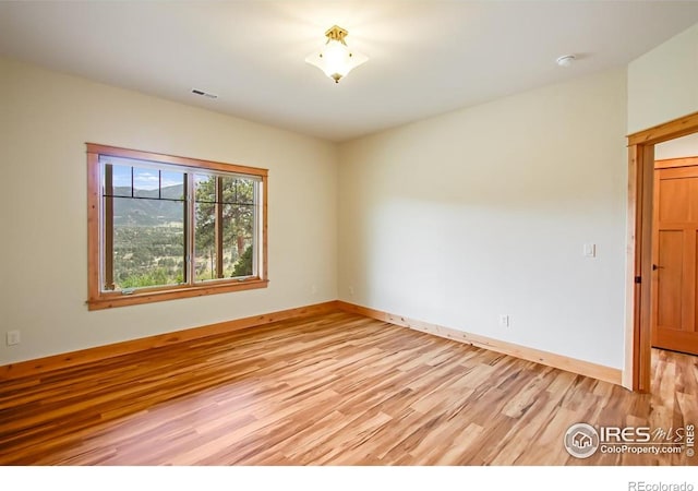 303 Curry Dr, Estes Park, CO 80517 - spare room with light wood finished floors, baseboards, and a smoke detector