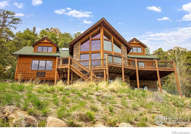 303 Curry Dr, Estes Park, CO 80517 - rear view of house with a wooden deck, stairs, and stone siding