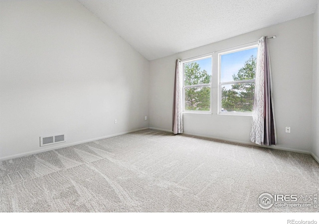 3022 W 107th Pl Unit D, Westminster, CO 80031 - spare room with carpet flooring, vaulted ceiling, baseboards, and a textured ceiling