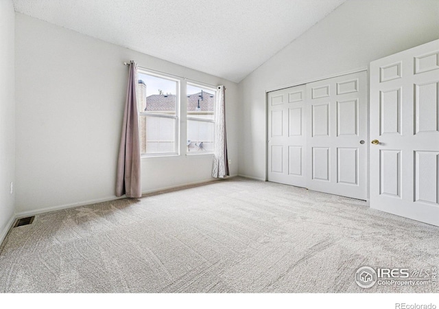 3022 W 107th Pl Unit D, Westminster, CO 80031 - unfurnished bedroom featuring carpet floors, vaulted ceiling, a closet, and baseboards
