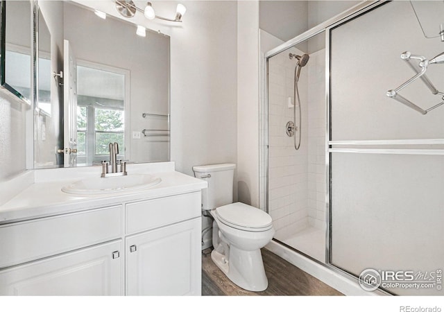 3022 W 107th Pl Unit D, Westminster, CO 80031 - full bathroom with a shower stall, toilet, vanity, and wood finished floors