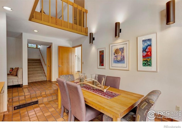 125 Saddleback Ln, Estes Park, CO 80517 - dining area featuring stairway, a towering ceiling, recessed lighting, and light tile patterned flooring