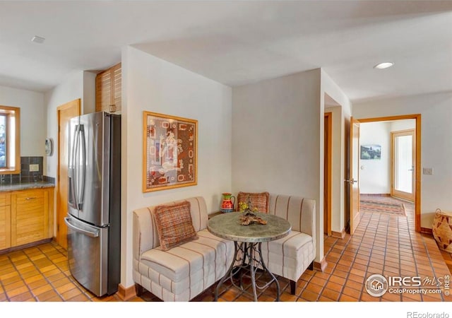 125 Saddleback Ln, Estes Park, CO 80517 - kitchen with stainless steel refrigerator with ice dispenser, light tile patterned floors, recessed lighting, baseboards, and light brown cabinetry