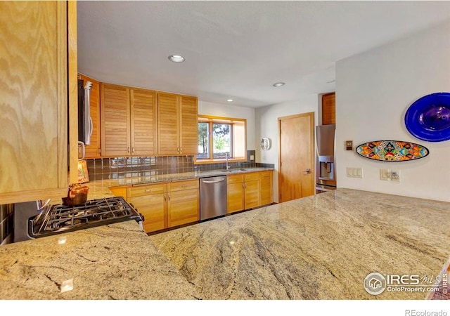 125 Saddleback Ln, Estes Park, CO 80517 - kitchen featuring stainless steel appliances, a sink, decorative backsplash, light stone counters, and recessed lighting