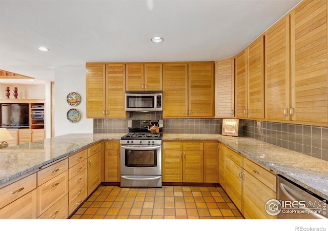 125 Saddleback Ln, Estes Park, CO 80517 - kitchen featuring appliances with stainless steel finishes, backsplash, recessed lighting, light stone counters, and light brown cabinetry