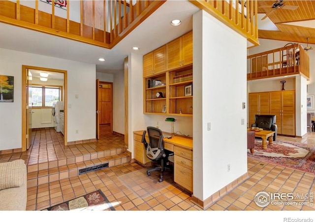 125 Saddleback Ln, Estes Park, CO 80517 - office space with built in desk, a towering ceiling, light tile patterned floors, recessed lighting, and baseboards