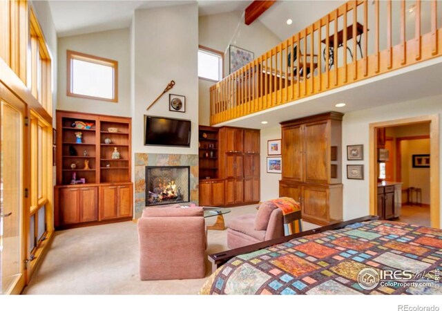 125 Saddleback Ln, Estes Park, CO 80517 - bedroom with a fireplace, high vaulted ceiling, beam ceiling, light colored carpet, and recessed lighting