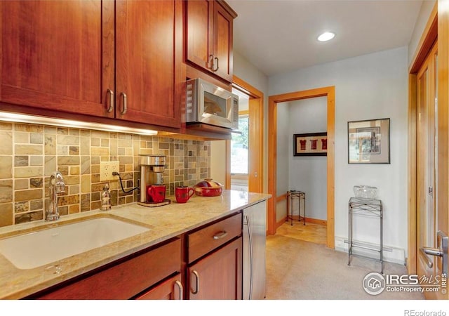 125 Saddleback Ln, Estes Park, CO 80517 - kitchen with a sink, stainless steel microwave, light carpet, backsplash, and light stone counters