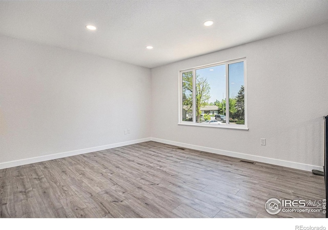 15904 E Bates Pl, Aurora, CO 80013 - spare room with recessed lighting, wood finished floors, and baseboards