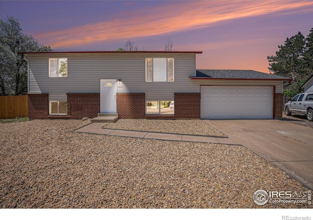15904 E Bates Pl, Aurora, CO 80013 - view of front facade with brick siding, driveway, and a garage