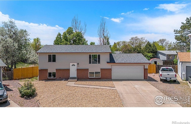 15904 E Bates Pl, Aurora, CO 80013 - raised ranch with an attached garage, concrete driveway, and brick siding