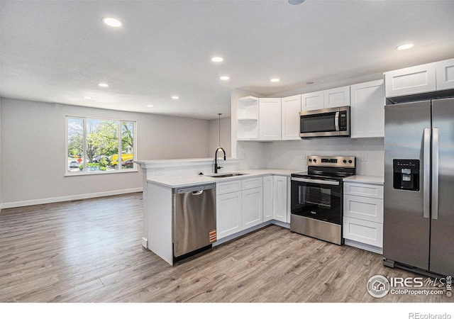15904 E Bates Pl, Aurora, CO 80013 - kitchen with appliances with stainless steel finishes, a sink, light wood finished floors, recessed lighting, and light countertops