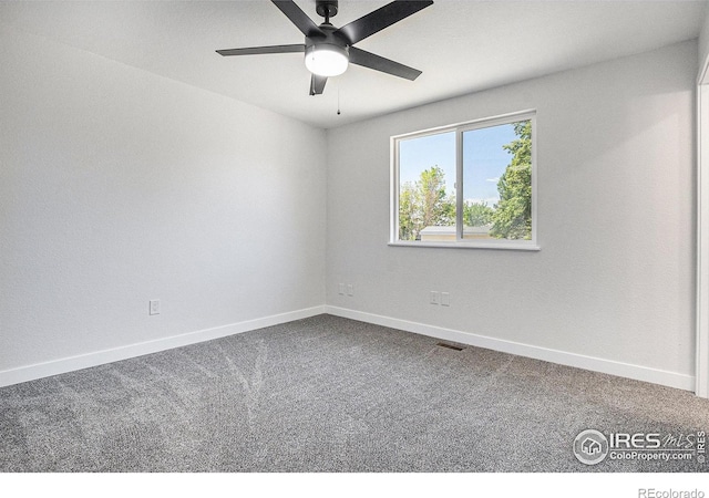 15904 E Bates Pl, Aurora, CO 80013 - empty room featuring dark colored carpet and baseboards
