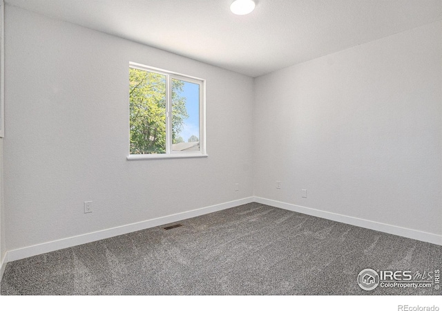 15904 E Bates Pl, Aurora, CO 80013 - empty room with dark carpet and baseboards