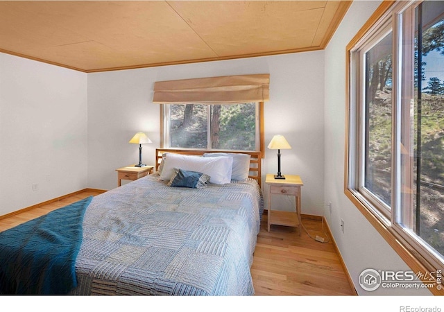 398 Fred Rd, Boulder, CO 80302 - bedroom featuring wood finished floors, crown molding, and baseboards