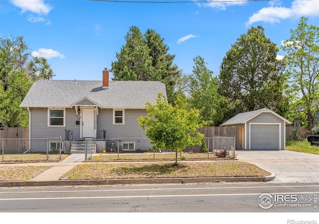 618 16th St, Greeley, CO 80631 - view of front of home featuring a detached garage, a chimney, a fenced front yard, and driveway
