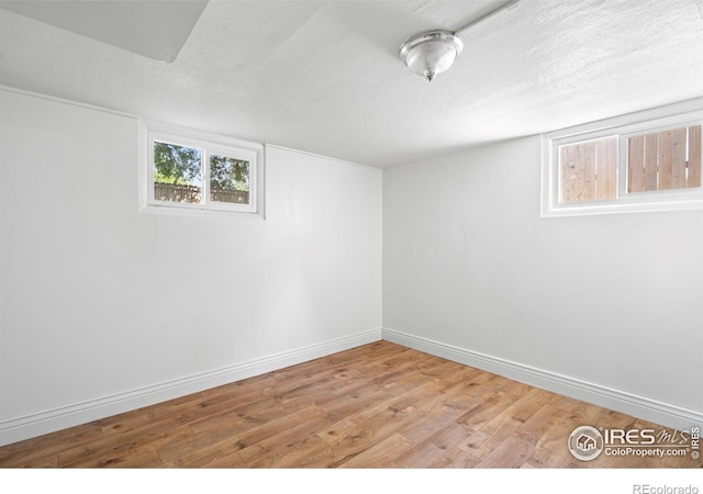 618 16th St, Greeley, CO 80631 - below grade area with wood finished floors, baseboards, and a textured ceiling