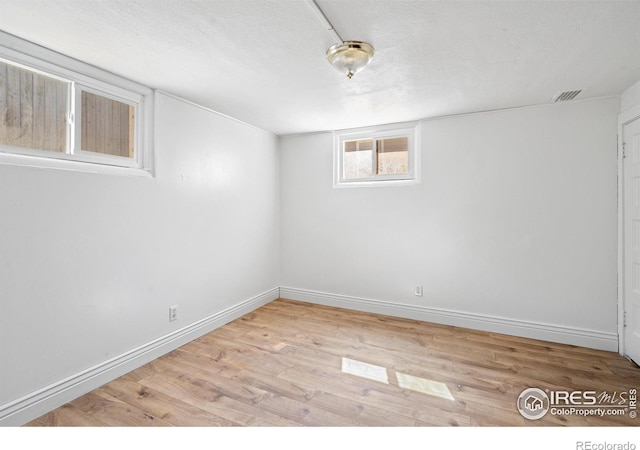 618 16th St, Greeley, CO 80631 - below grade area with wood finished floors, baseboards, and a textured ceiling