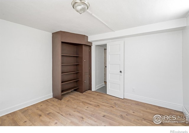 618 16th St, Greeley, CO 80631 - unfurnished bedroom with wood finished floors and baseboards