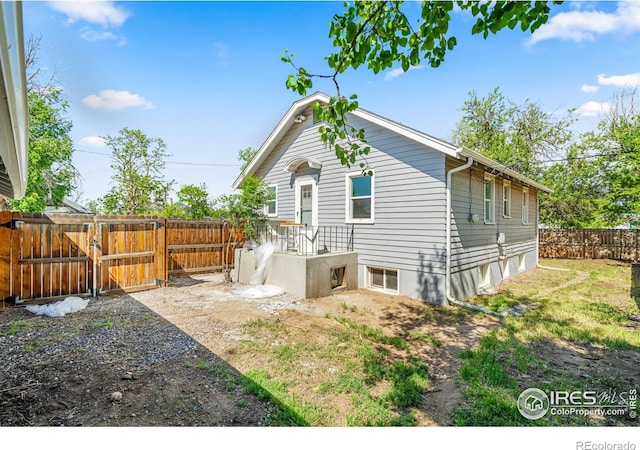 618 16th St, Greeley, CO 80631 - back of house featuring a fenced backyard and a gate