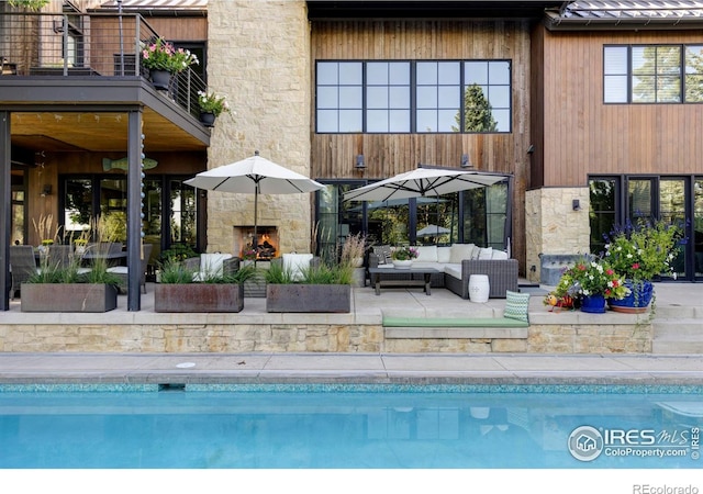 3737 Spring Valley Rd, Boulder, CO 80304 - outdoor pool featuring an outdoor living space with a fireplace and a patio